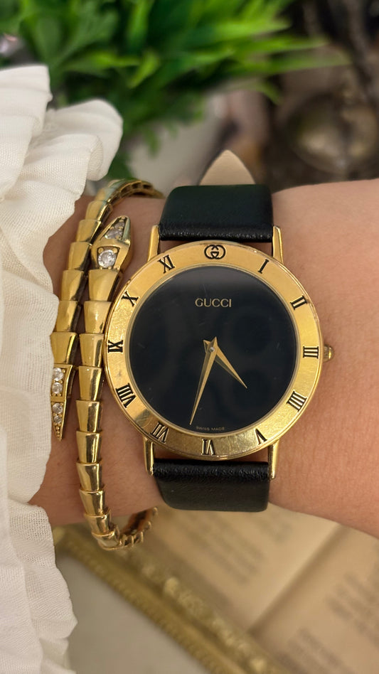 Vintage Gucci Swiss 3000 M Engraved Roman Bezel Mens Watch in Gold Tone Black Leather Blackout Dial Quartz