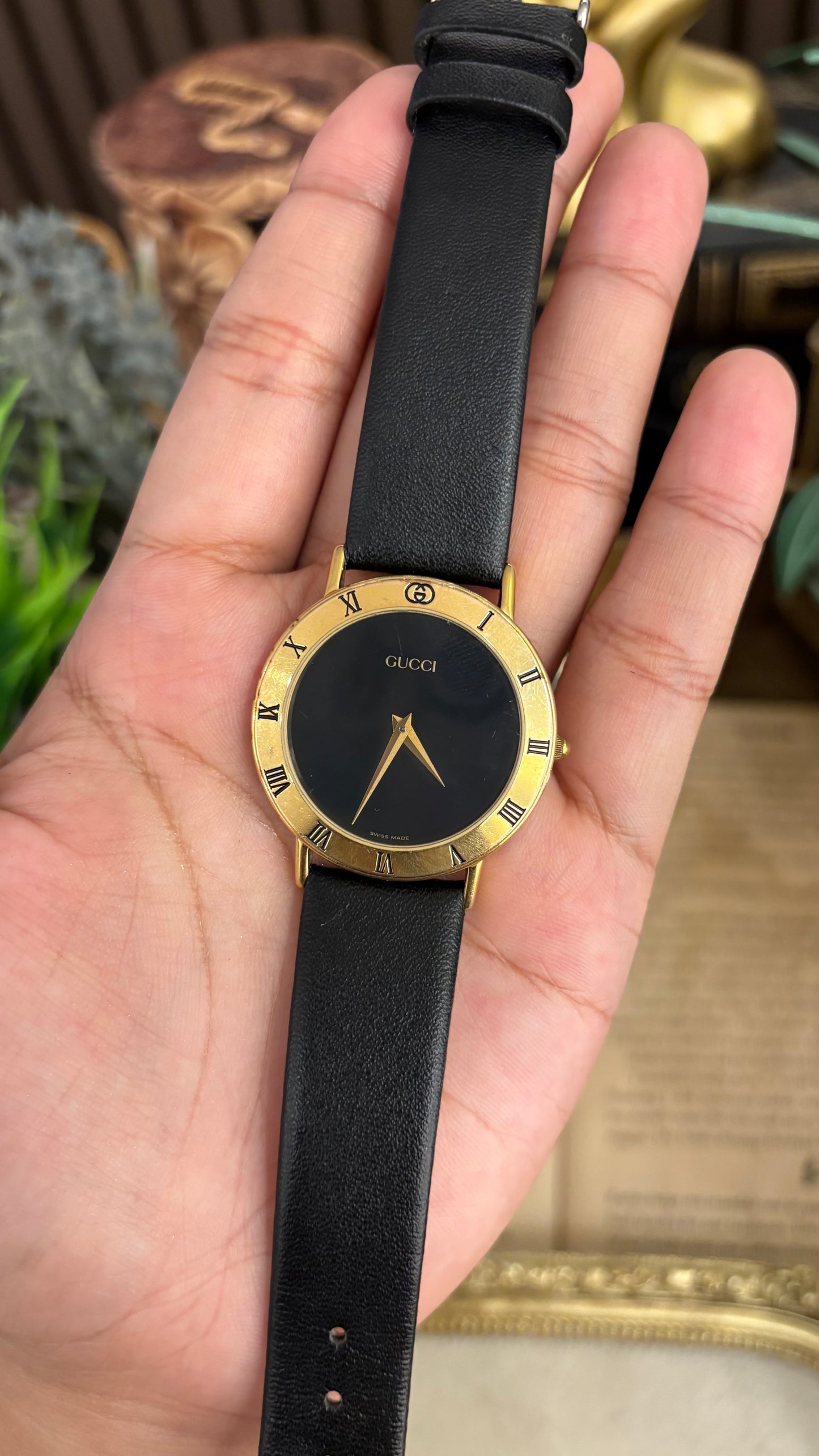 Vintage Gucci Swiss 3000 M Engraved Roman Bezel Mens Watch in Gold Tone Black Leather Blackout Dial Quartz