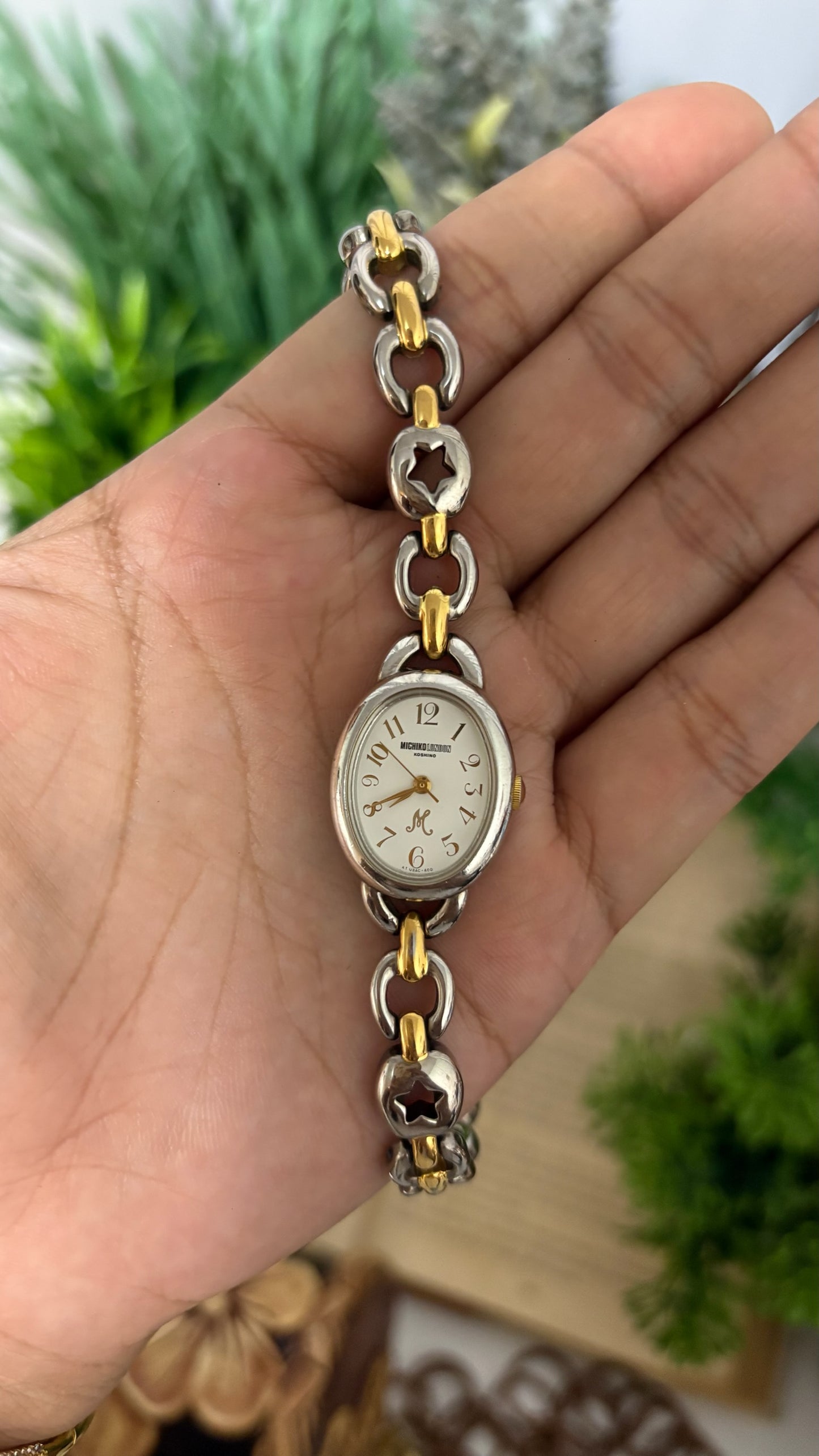 Vintage Michiko London Koshino Oval Case Watch with Two-Tone Interlocking Figure-8 Link Bracelet and Star Cutouts in Silver and Gold Tone White Dial Quartz
