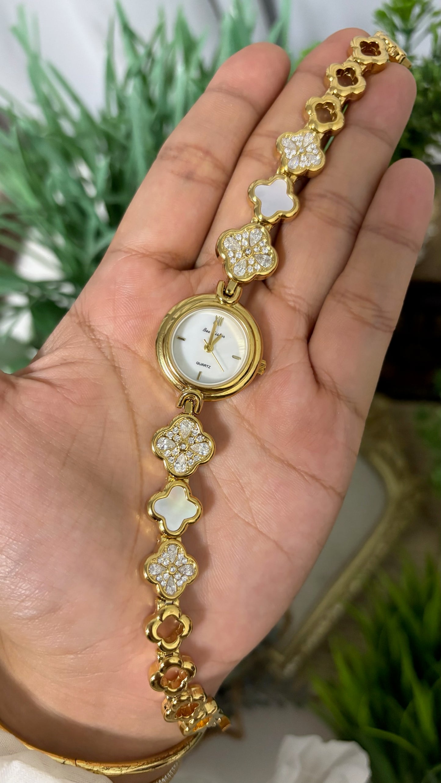 Vintage BS Bee Sister Round Watch with White Dial, Polished Gold Tone Bezel, and Quatrefoil Clover Link Bracelet Alternating with Crystal Pave and White Inlay Details Quartz