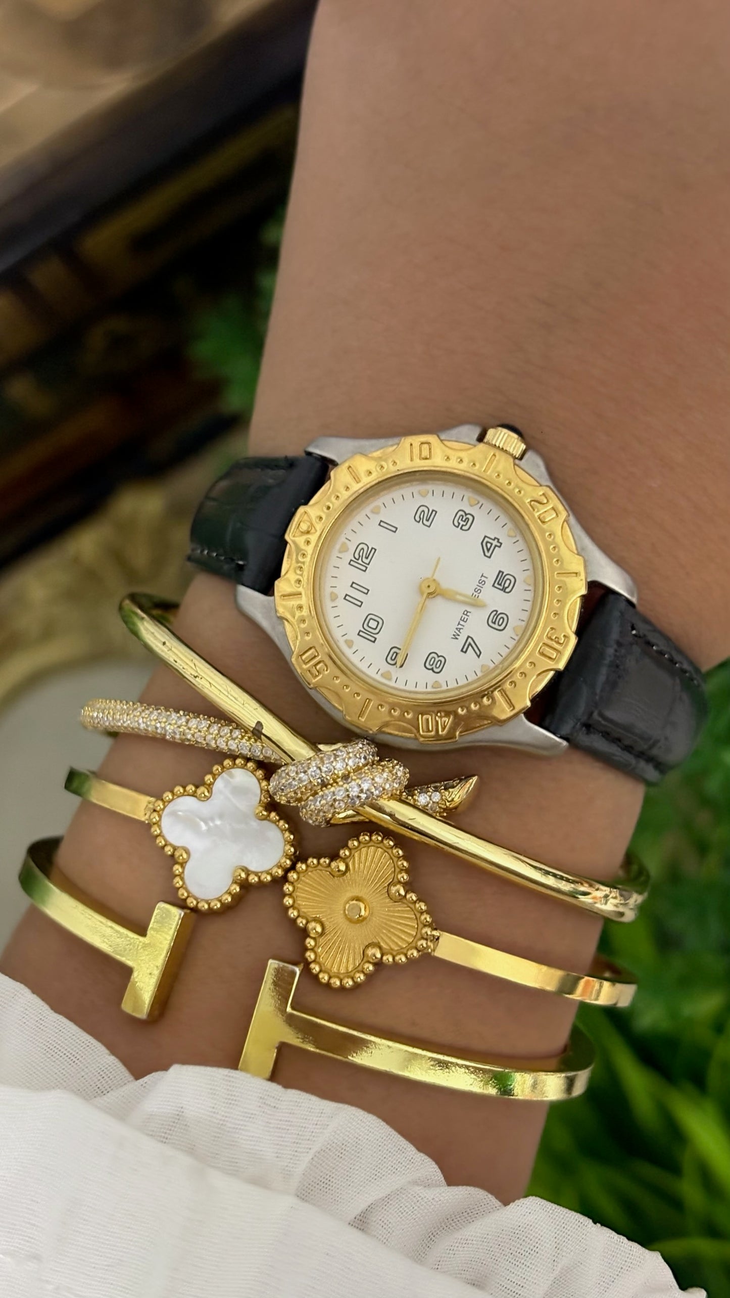 Vintage Noevir Round Sporty Watch with White Dial Full Arabic Numerals Gold Tone Rotating Style Bezel Two-Tone Silver and Gold Case and Black Croc Embossed Leather Strap Quartz