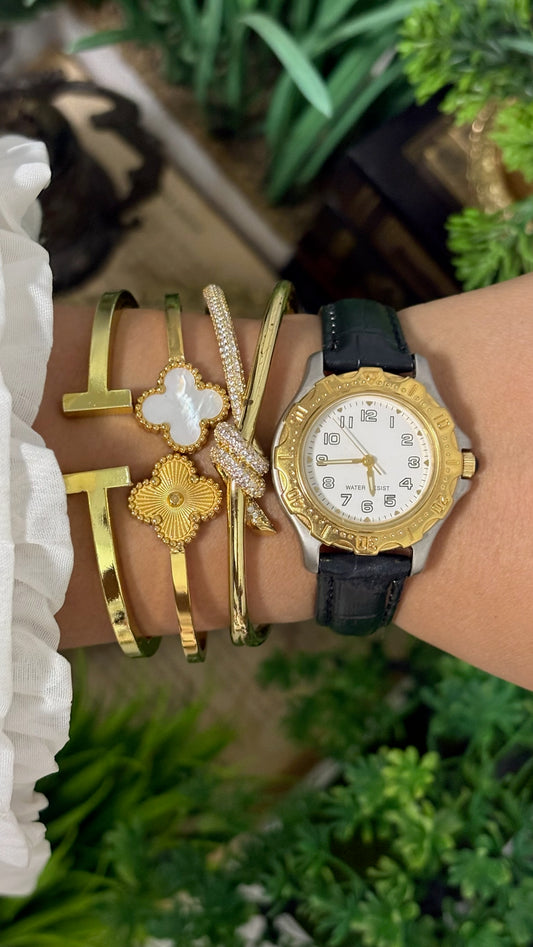 Vintage Noevir Round Sporty Watch with White Dial Full Arabic Numerals Gold Tone Rotating Style Bezel Two-Tone Silver and Gold Case and Black Croc Embossed Leather Strap Quartz
