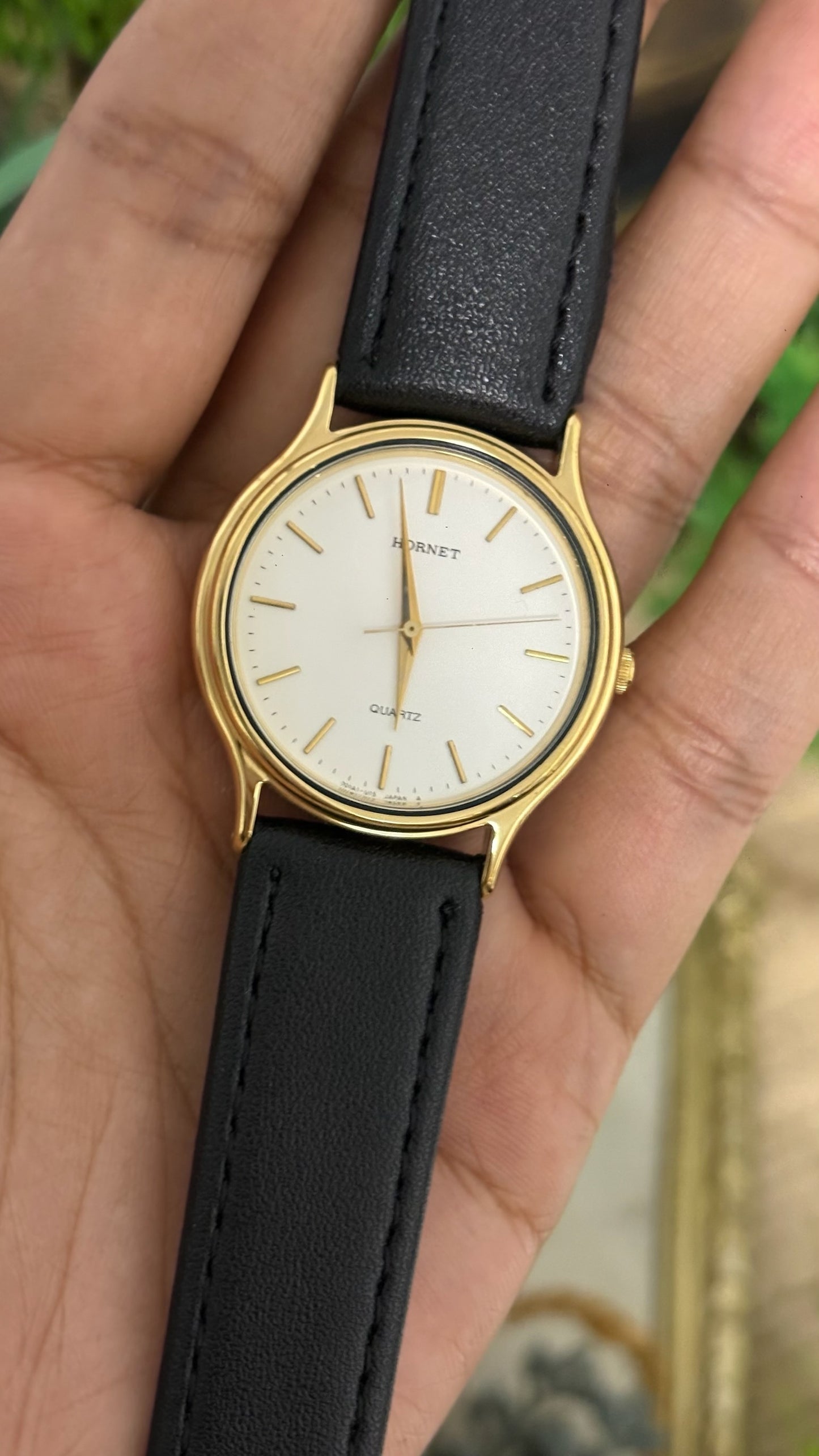Vintage Hornet Round Watch with White Dial Minimalist Stick Markers Polished Gold Tone Case and Smooth Black Leather Strap Quartz
