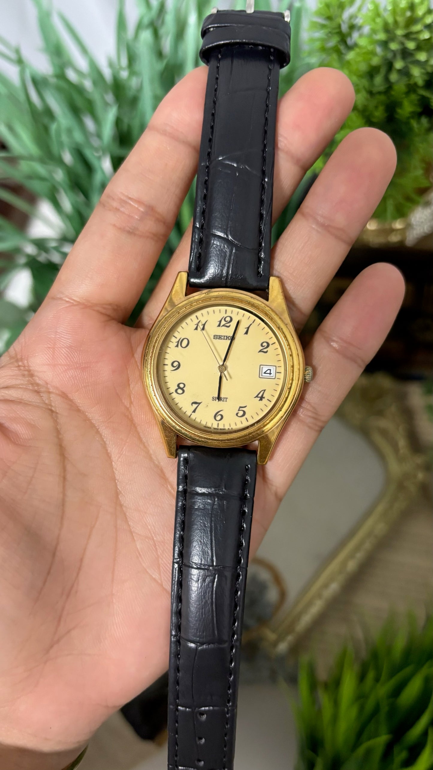 Vintage Seiko Spirit Mens Round Watch with Champagne Dial Full Arabic Numerals Date Window Polished Gold Tone Case and Black Croc Embossed Leather Strap Quartz